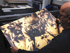 Mark Foxwell from Genesis Imaging inspects a metal print for the Liquid Gold exhibition.